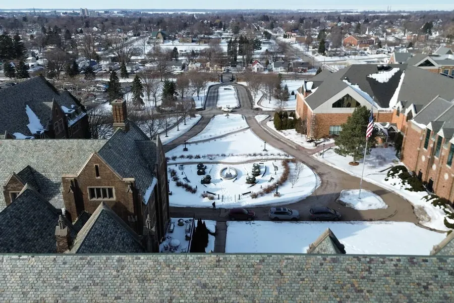 The main campus courtyard and fountain under snow, seen from the air