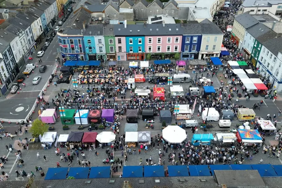 Street festival with tents and crowds photographed from the air