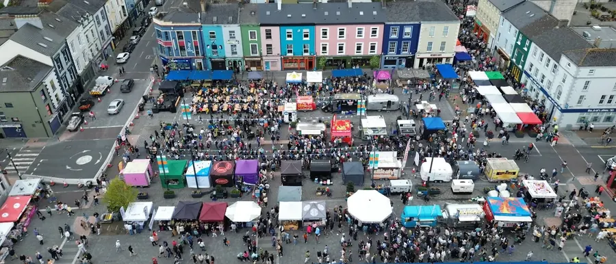 Market stalls in a town square photographed from above